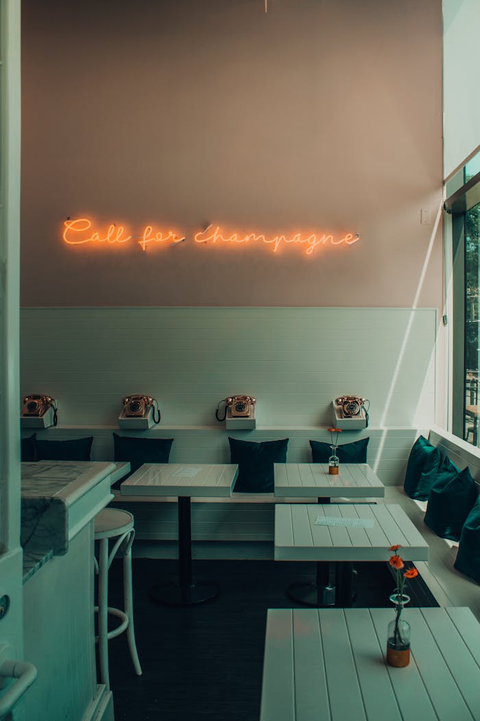 Chic retro cafe in Toronto featuring a 'Call for champagne' neon sign. Ideal for social gatherings.